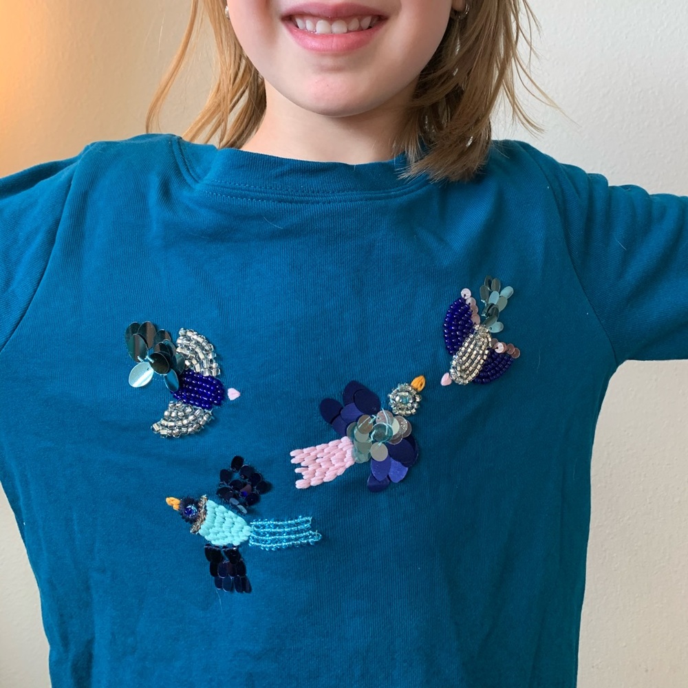 Beaded and embroidered birds on kids sweater